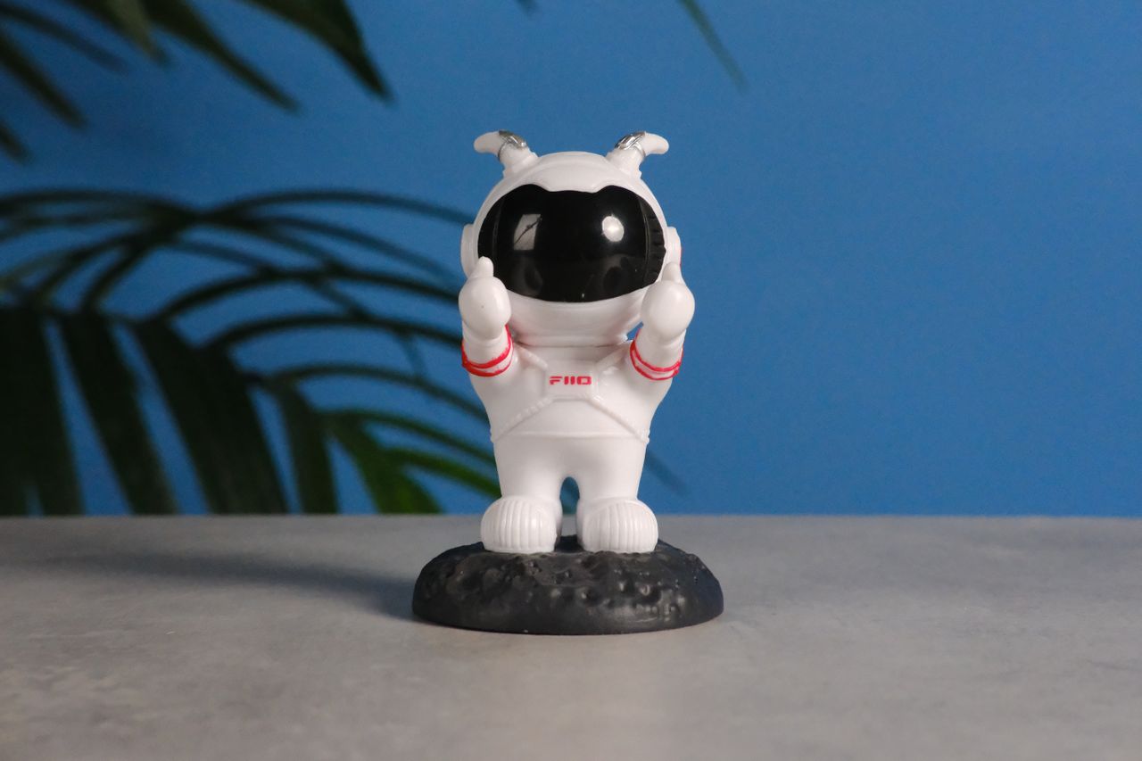 A photo of an astronaut toy against a blue background, taken on the Fujifilm X-E5