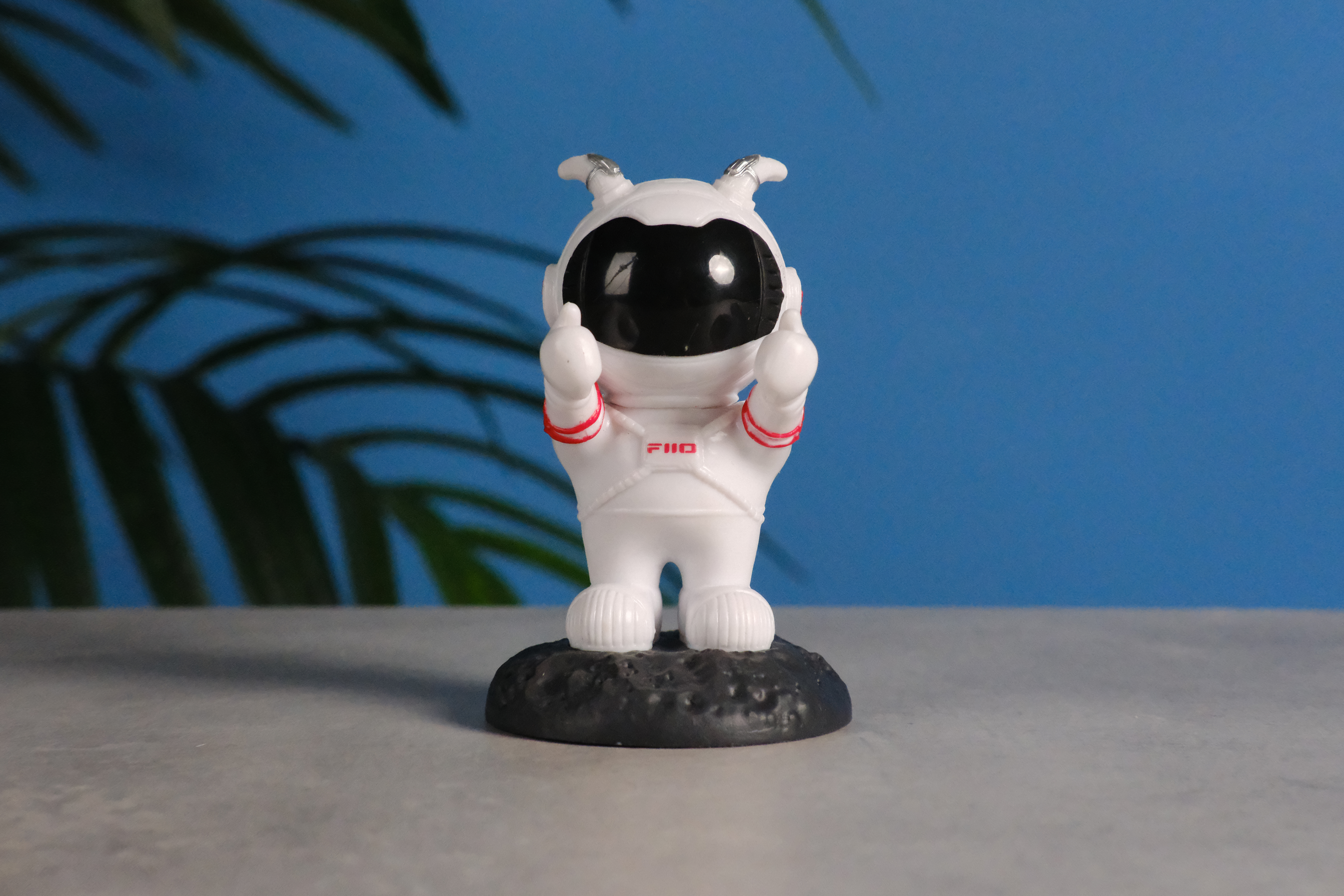 A photo of an astronaut toy against a blue background, taken on the Fujifilm X-E5