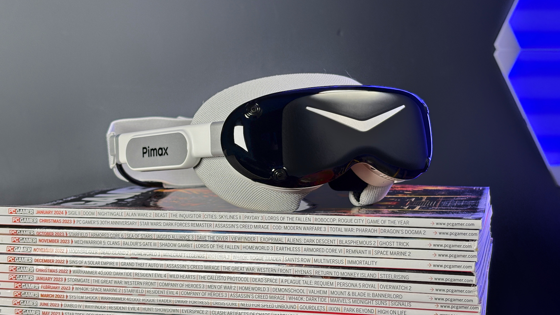 The Pimax Dream Air in white on a stack of PC Gamer magazine.