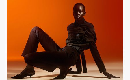 Shrug; shirt; trousers; shoes, all by Prada. Minimalist womenswear for S/S 2021