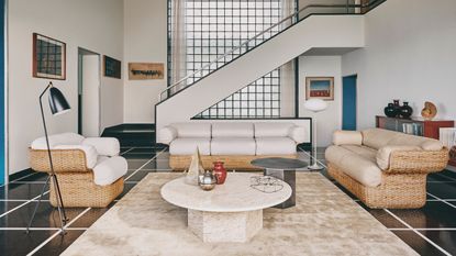 Travertine table in a living room by GUBI