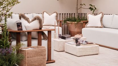 A still from Nth Degree's exhibit at the 2025 Chelsea Flower Show featuring outdoor sofas, block coffee tables, a jute bag and a potted tree