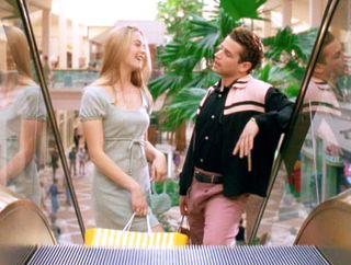Cher Horowitz (Alicia Silverstone) wearing a green mini dress with Christian ( Justin Walker) in Clueless