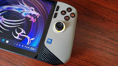 Close up of MSI Claw 8 AI+ handheld on woodgrain desk.