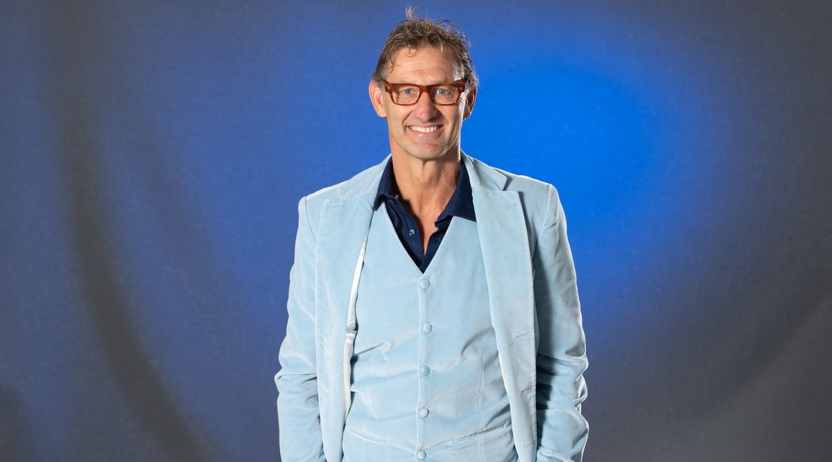 Portrait shot of Tony Adams wearing a suit