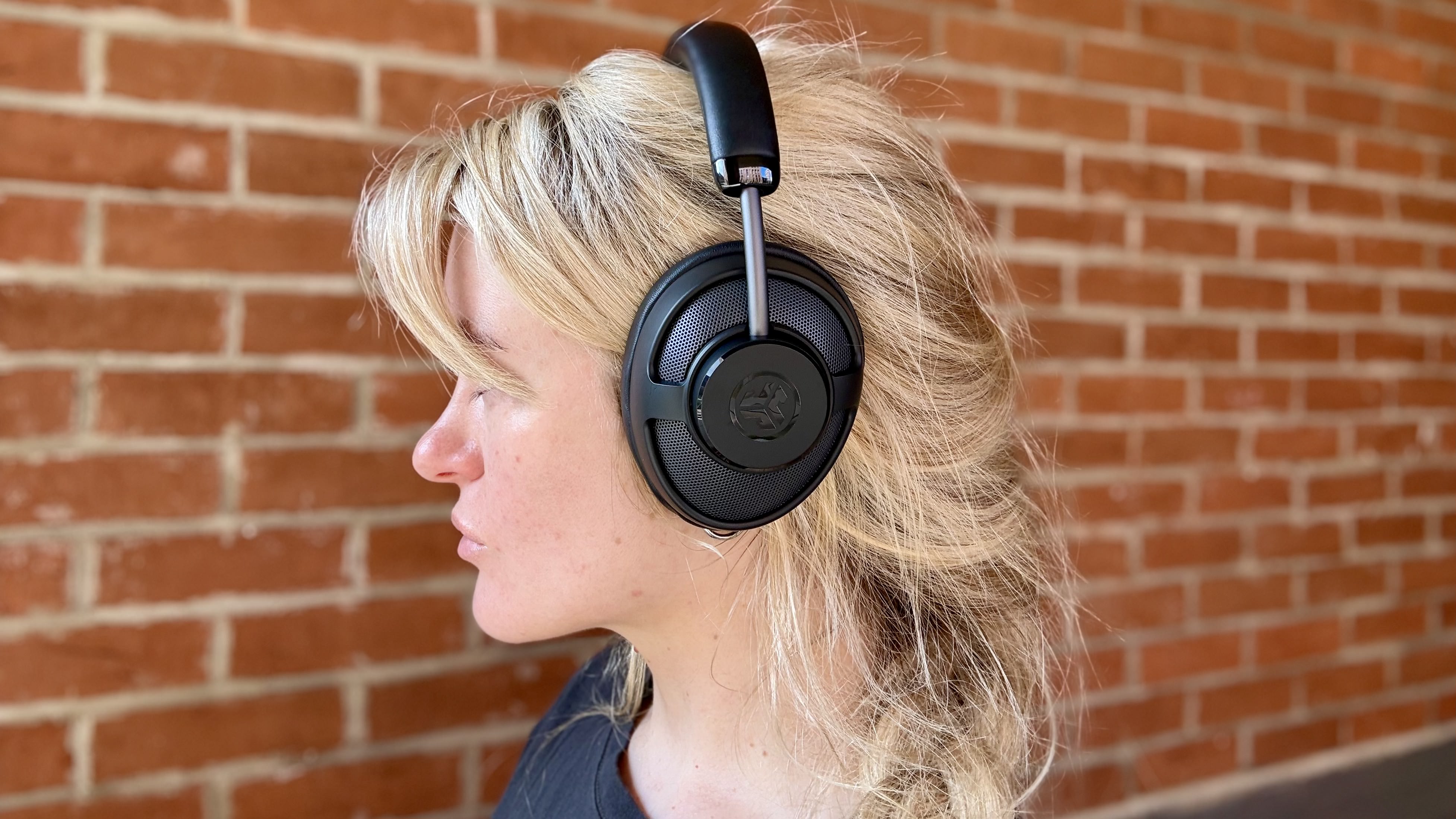 Becca Caddy wearing the jlab jbuds open wireless headphones