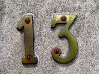 a gold plated number thirteen