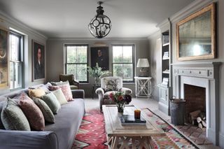 grey living room with large colourful area rug and art by Ham Interiors