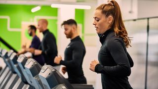 Four gym goers running on treadmills in a Gym Group facility 