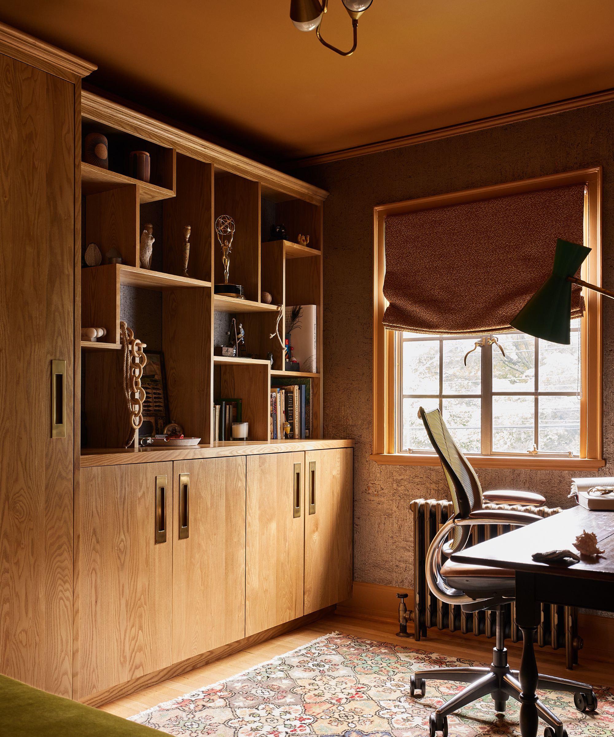a warm home office with a golden ochre ceiling and custom warm wood cabinetry