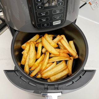 Cooked chips in the basket of a Ninja AF100UK Air Fryer