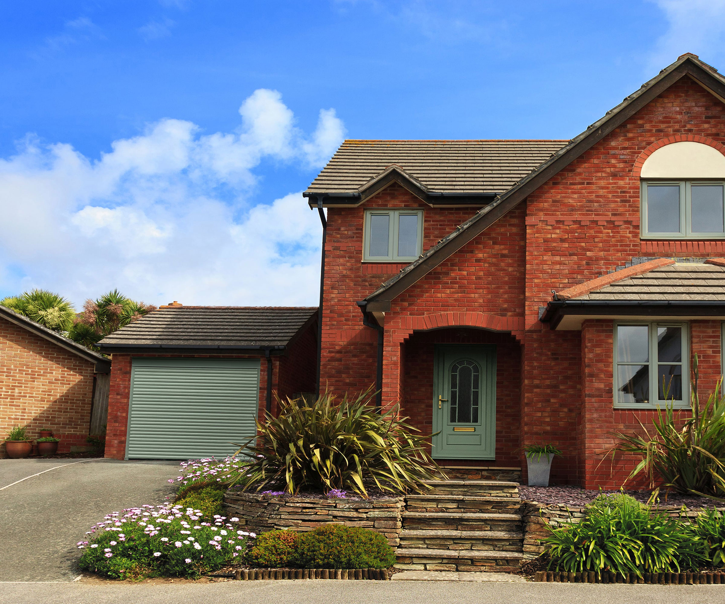 sloping driveway with steps up to house