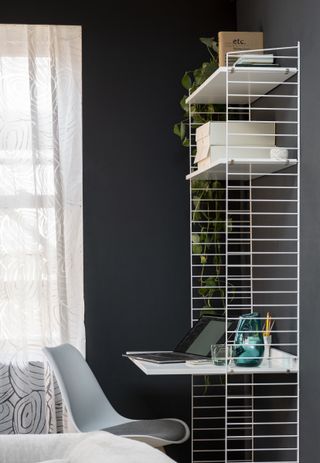 black home office with white shelving desk