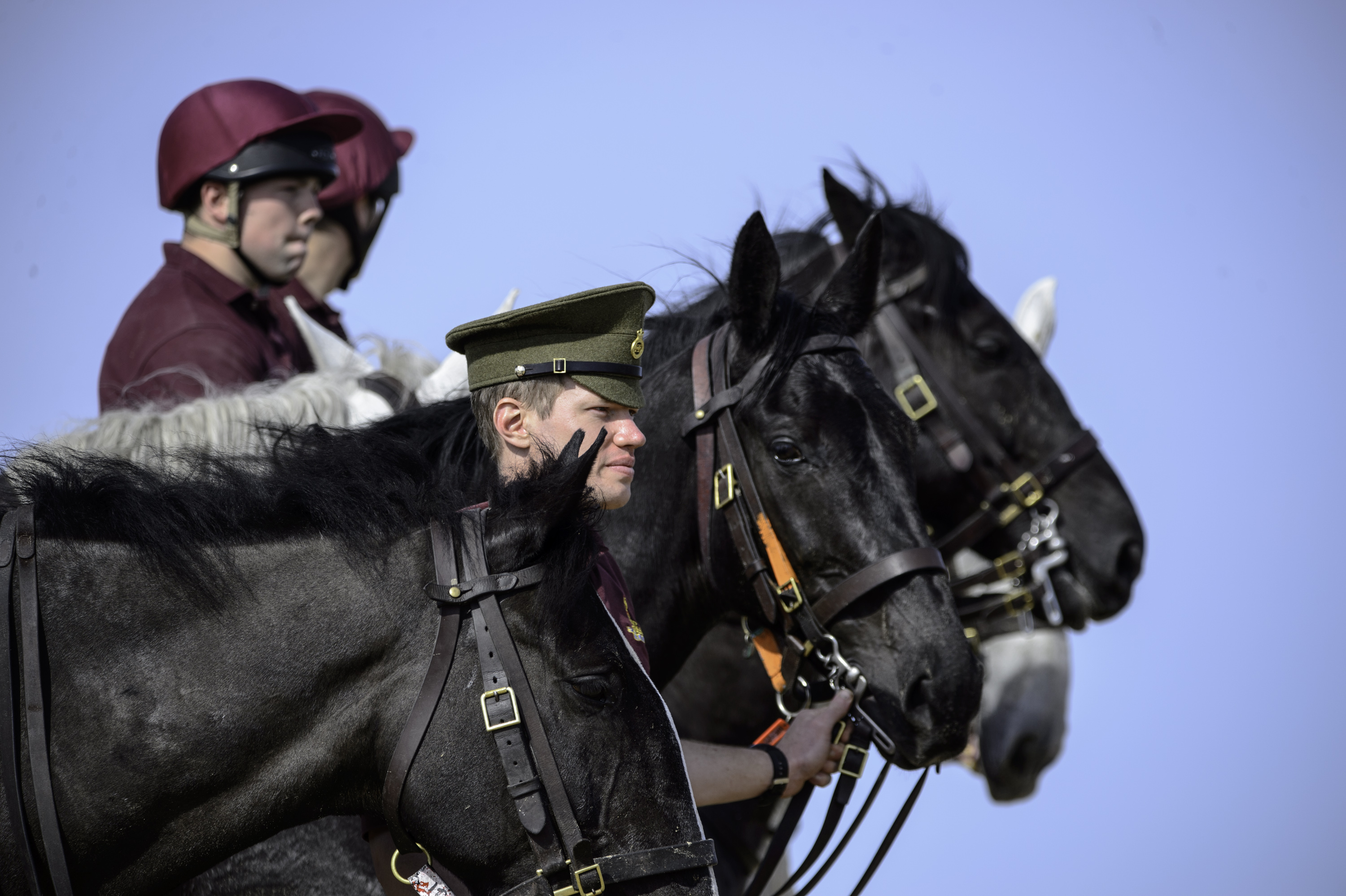 Trooper Van Vwran stands with horses of The Queen’s Life Guard on the beach