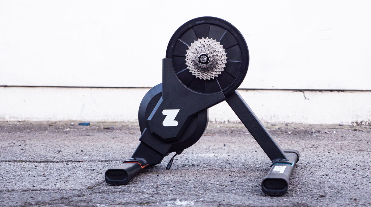 A Zwift Hub trainer stands on a tarmac road