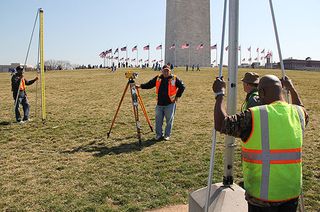 Surveyors prepare to take a height measurement near the Washington Monument.