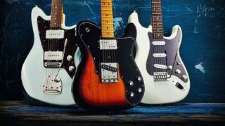 Three Squier electric guitars on a blue background