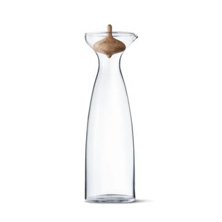 A tall glass carafe with a wooden stopper