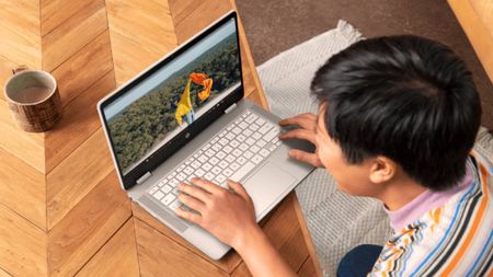 HP Chromebook being used by a man on a table