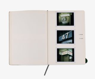 Three polaroid photos are glued in a notebook.