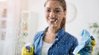 Woman cleaning window