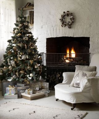 Christmas tree with silver, white and gold decorations in keeping with the neutral farmhouse living room