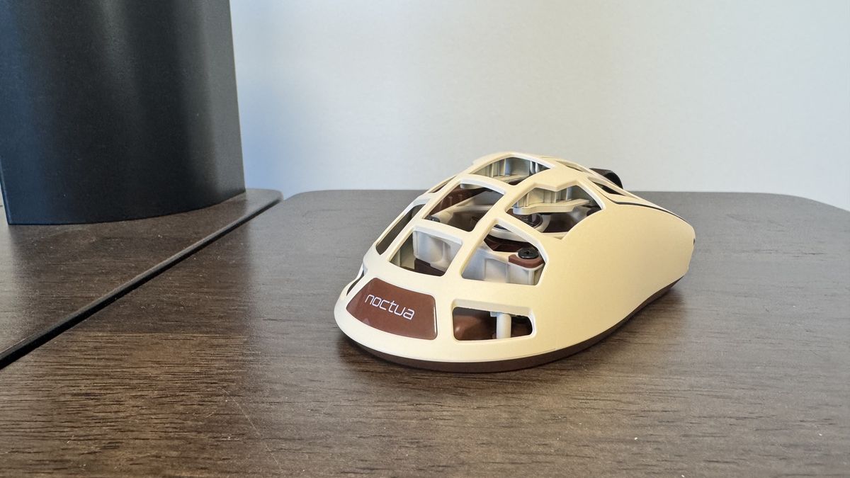 The Pulsar Feinmann F01 Noctua Edition gaming mouse from the back right on a wooden desk