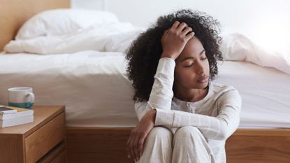 A woman wondering why her head hurts when lying down