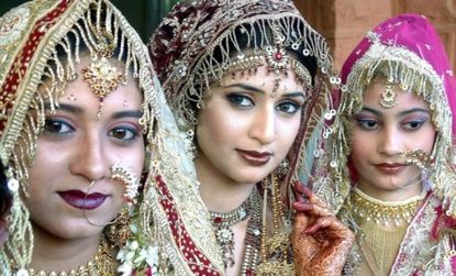 Models display wedding outfits during a bridal event in Delhi: The food component is equally elaborate, with families flying in foreign chefs to cook a dizzying array of wedding dishes.