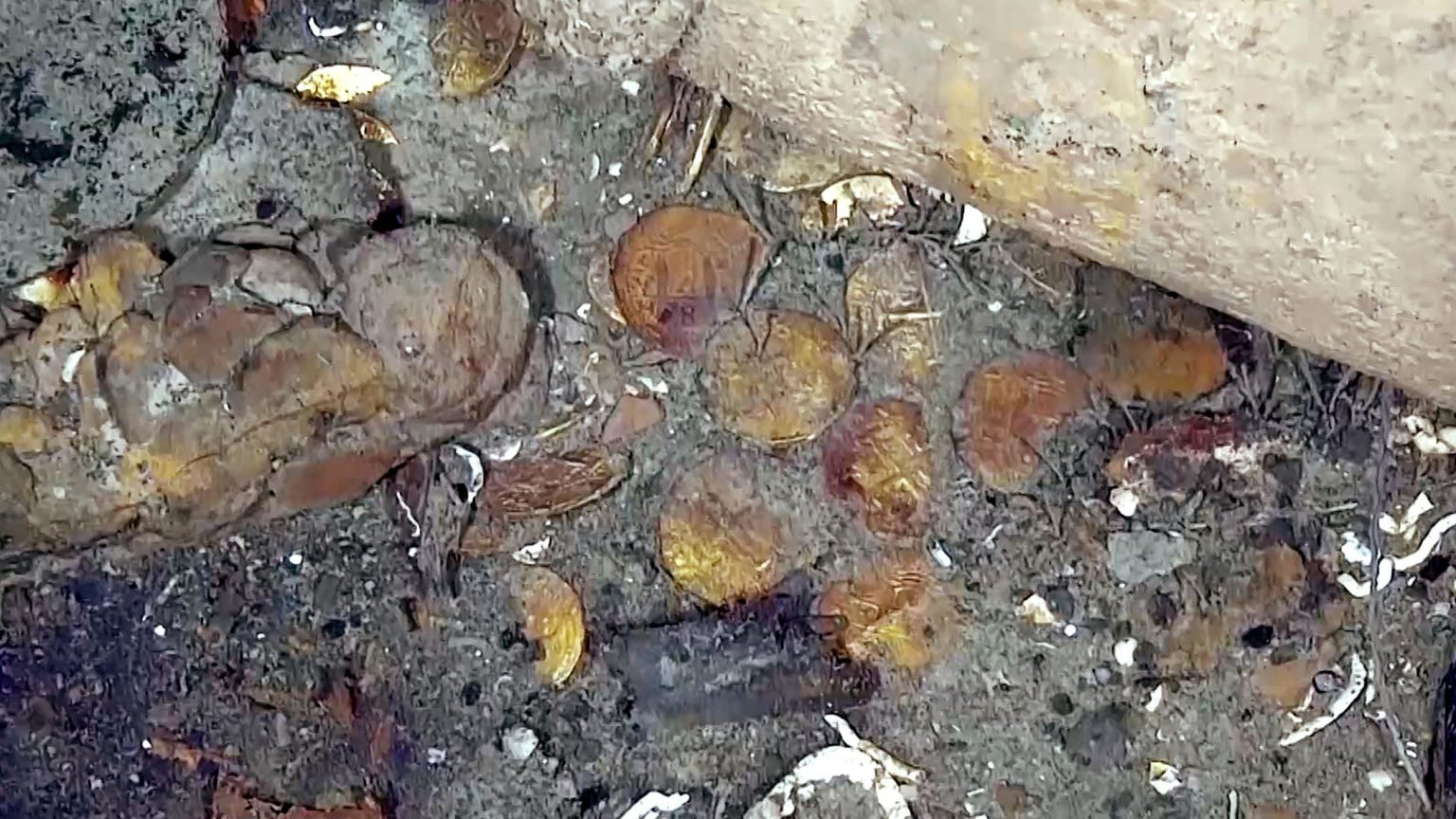 The latest photographs and video also show gold coins from the ship's cargo of treasure, now lying on the seafloor.