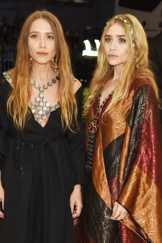 Mary-Kate and Ashley Olsen with long wavy hair.
