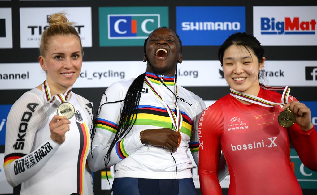 Gold medalist Frances Taky Marie Divine Kouame C celebrates on podium with silver medalist Germanys Emma Hinze L and bronze medalist Chinas Yufang Guo R after the Womens 500m time trial final during the UCI Track Cycling World Championships at the Velodrome of SaintQuentinenYvelines southwest of Paris on October 15 2022 Photo by AnneChristine POUJOULAT AFP Photo by ANNECHRISTINE POUJOULATAFP via Getty Images