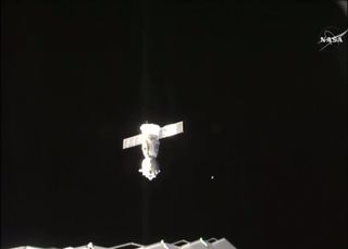 Soyuz spacecraft visible detached from International Space Station.