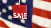 Memorial Day sales tag against an American flag