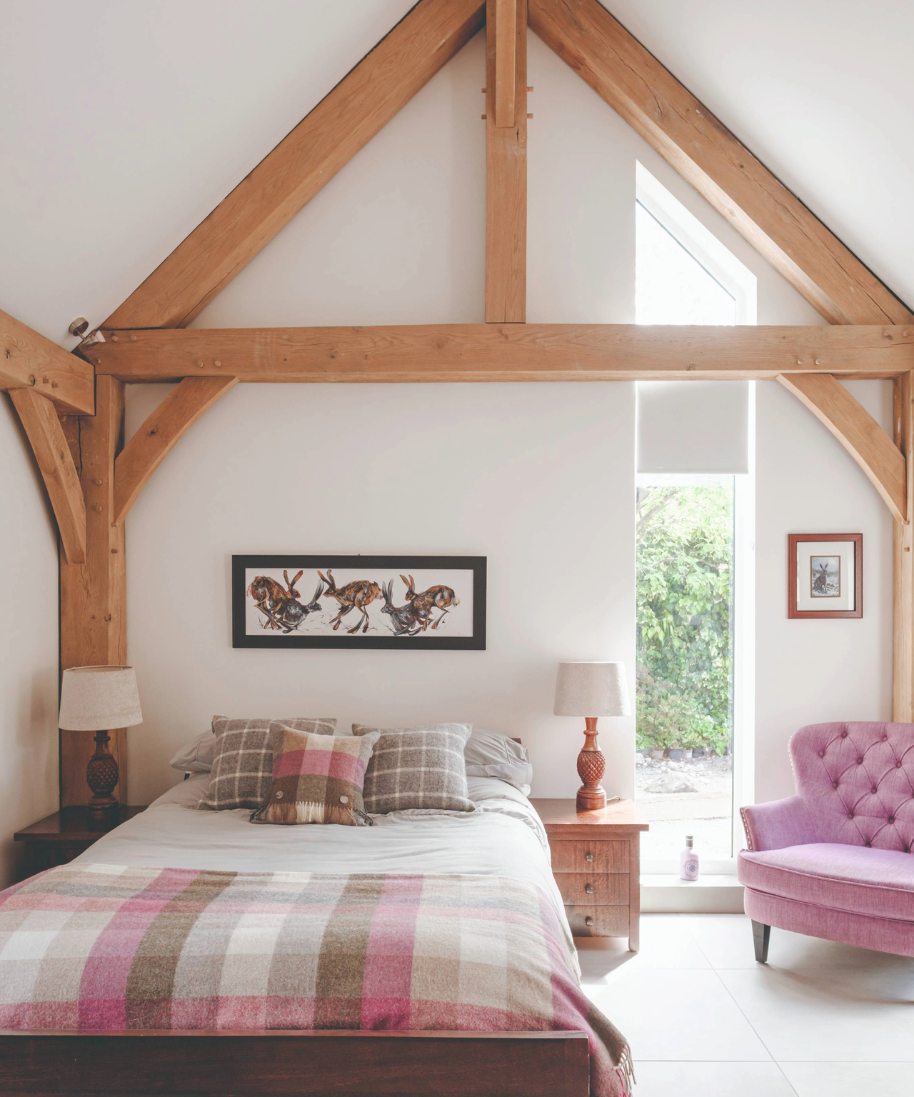Bedroom with wooden beams and purple chair