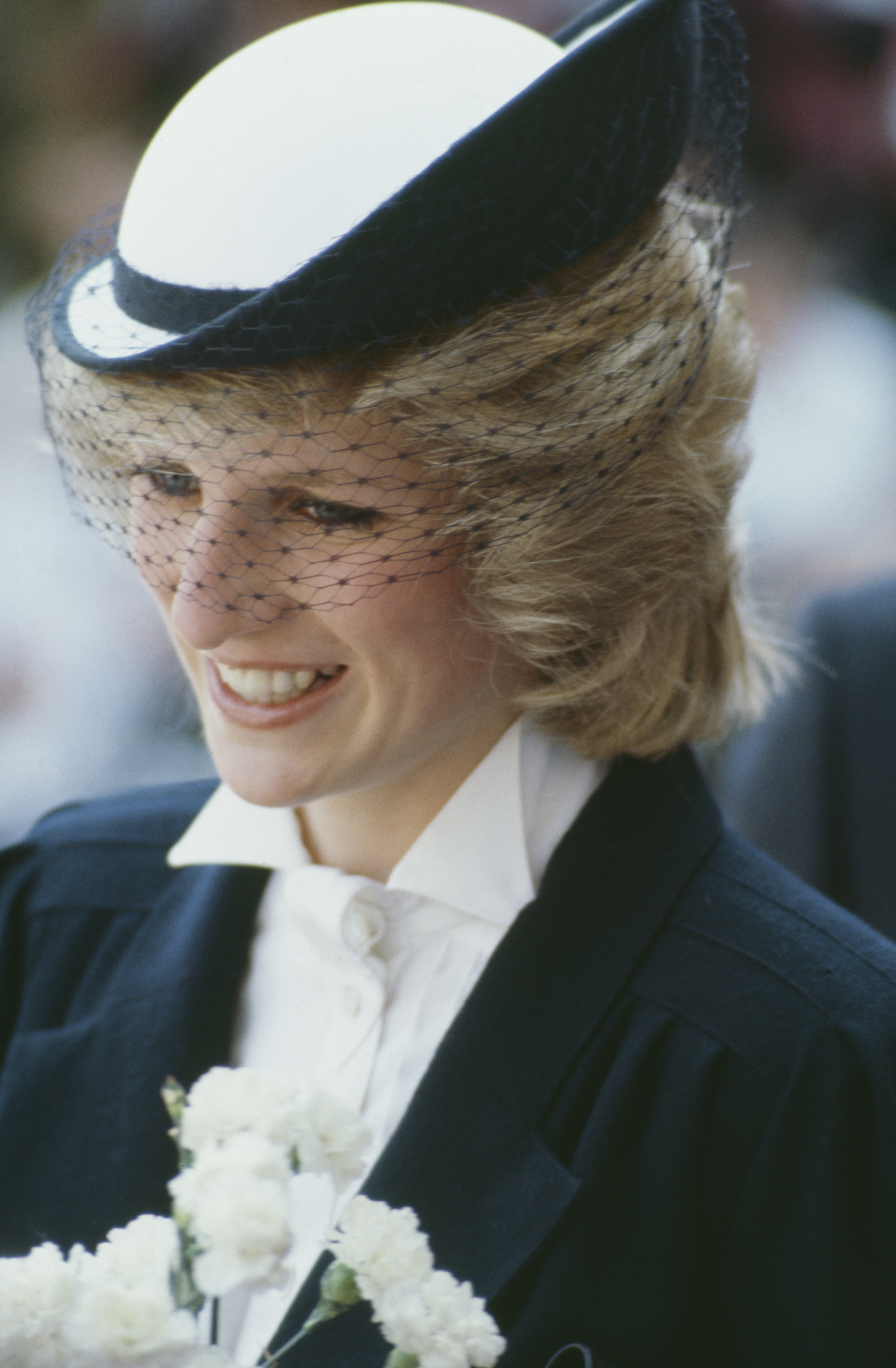 Princess Diana wearing a black and white outfit and hat with a veil