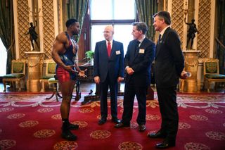 Gladiator Nitro, also known as Harry Aikines-Aryeetey speaks with British actors Matt Lucas and Rob Brydon during a reception hosted by Britain's Queen Camilla for finalists, judges and celebrity readers, to celebrate the final of the BBC's creative writing competition at Buckingham Palace in central London on February 26, 2025