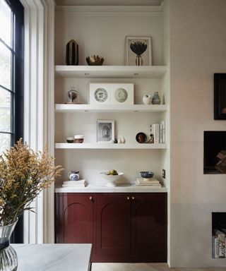red gloss small cabinet with open shelving in an alcove