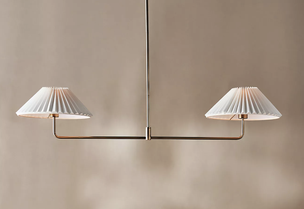 Timelessly modern chandelier featuring double pleated lamp shades.