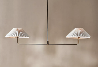 Timelessly modern chandelier featuring double pleated lamp shades. 
