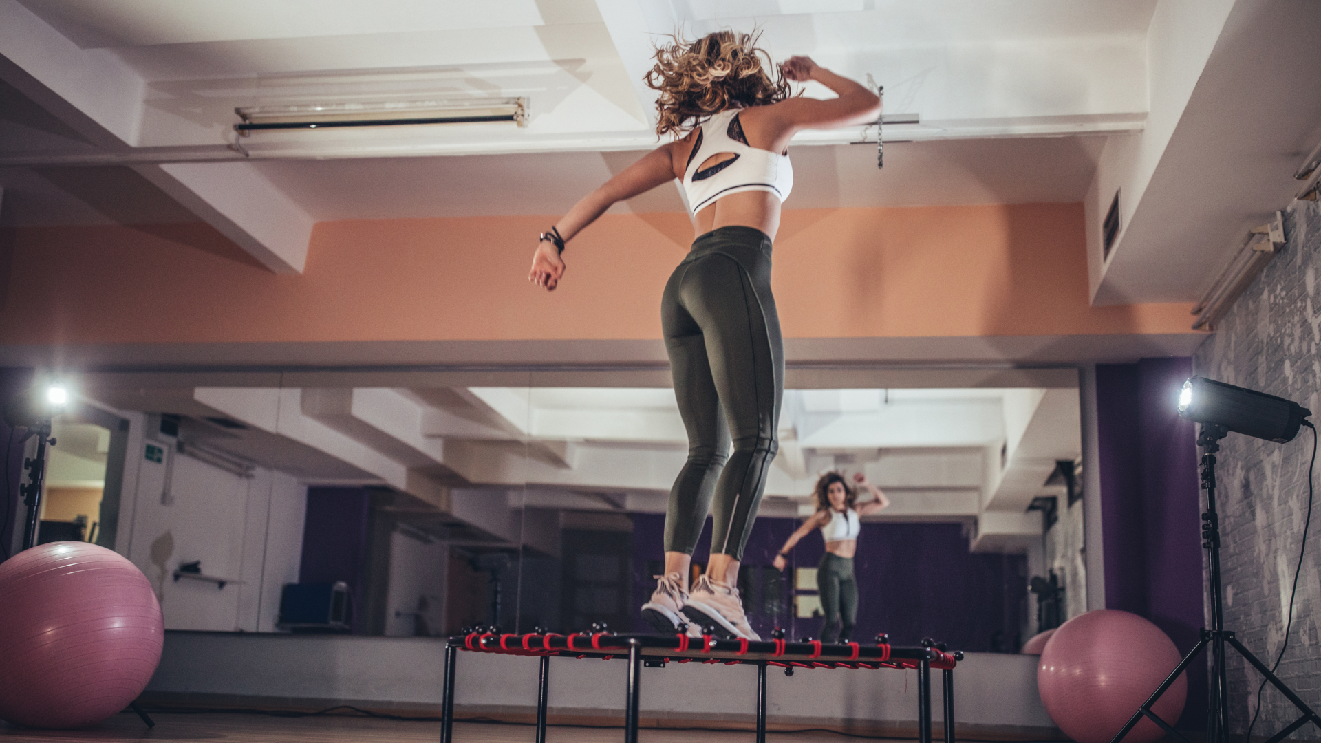 A woman jumping on a rebounder
