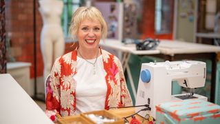 Lizzie in a floral patterned cardigan and white shirt for The Great British Sewing Bee 2023