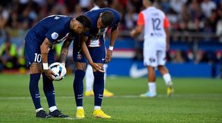 Neymar and Kylian Mbappe in conversation ahead of a penalty for PSG against Montpellier.
