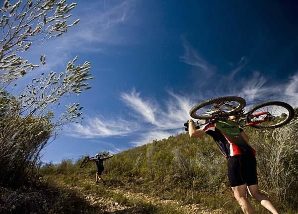 Two riders hike-a-biking.
