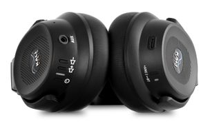 A pair of Kali Audio HP-1 headphones against a white background showing the connections and controls on the bottom of the ear cups