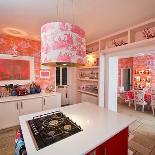 kitchen room with gas stove and printed wallpaper on wall