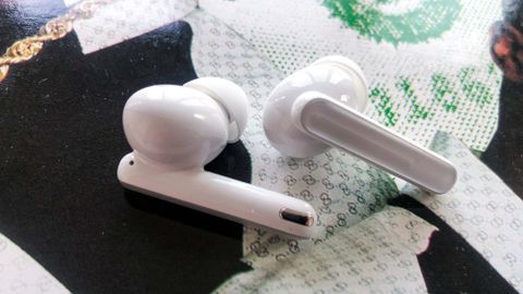 Oppo Enco Free2 earbuds on a record sleeve