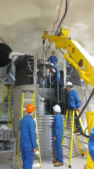 Scientists install the COUPP-60 detector a mile and a half underground at SNOLAB in Ontario, Canada.