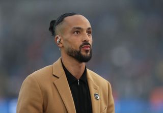 Theo Walcott looks on during the Premier League match between Brighton & Hove Albion and Arsenal FC at American Express Community Stadium on April 6, 2024 in Brighton, England.(Photo by Crystal Pix/MB Media/Getty Images)