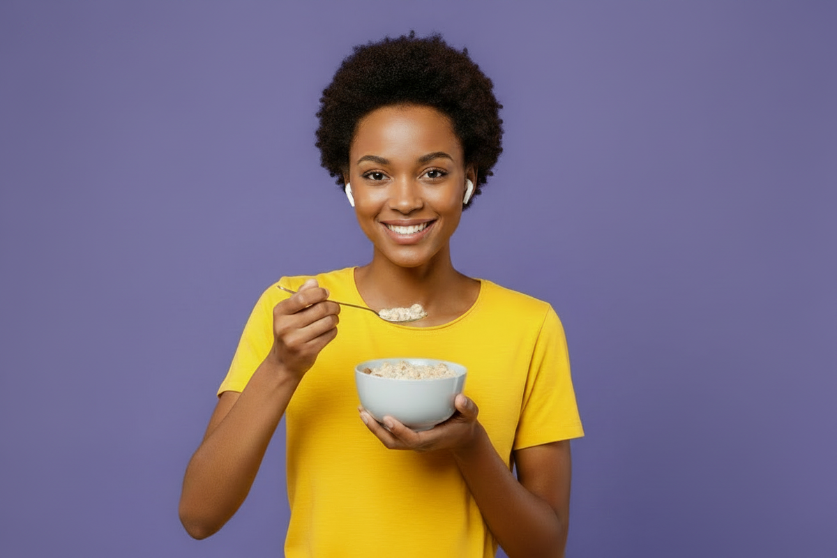 A person eating cereal against a color background